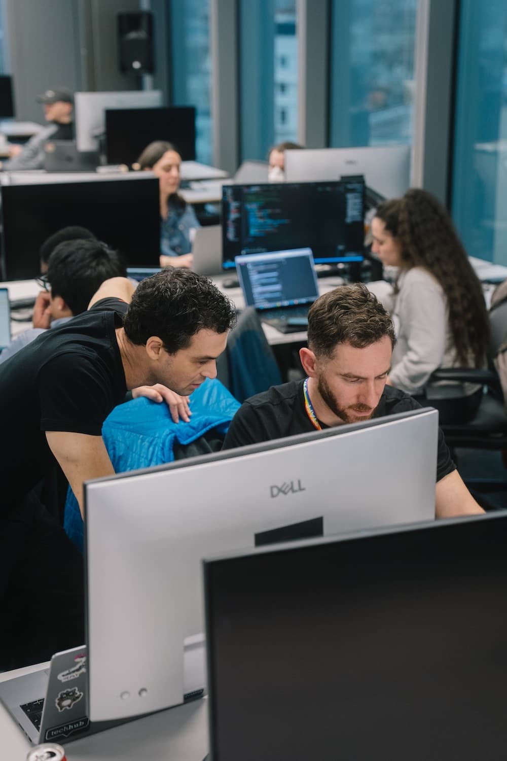 Two software developers collaborating at a workstation